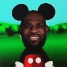 lebron james is wearing mickey mouse ears and holding mickey mouse .