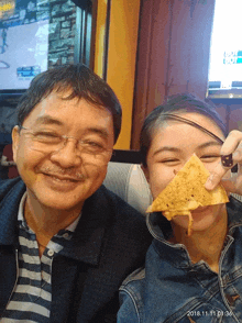 a man and a girl are posing for a picture with the date of 2018.11.11