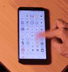 a person is using a smart phone with a lot of icons on the screen