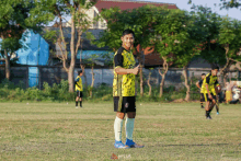 a soccer player wearing a yellow and black shirt with the word plus on it