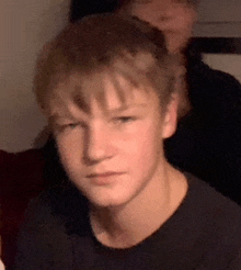 a close up of a young boy 's face with a blurred background