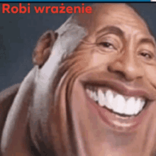 a close up of a man 's face with a big smile and the words robi wrazenie on the bottom .