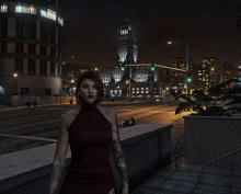 a woman in a red dress is standing on a sidewalk in front of a city at night