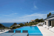 a swimming pool with a table and chairs in front of it