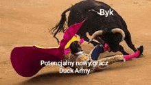 a matador is being attacked by a bull in a bullfight .