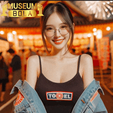 a woman wearing glasses and a tank top that says ' to el ' on it