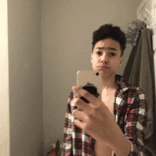 a young man taking a picture of himself in a mirror