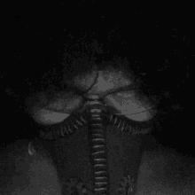 a black and white photo of a person wearing a mask