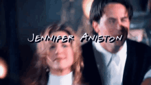 a man and a woman are standing next to each other with the name jennifer aniston written on the screen