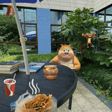 a cartoon bear sitting at a table with a cup of soda and a bag of chips