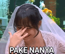 a woman in a wedding dress is covering her face with her hand and the words pake nyanyi are written below her