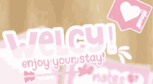 welcy enjoy your stay written on a pink background