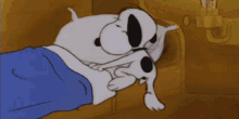 a cartoon of snoopy laying in a bed with a blue blanket