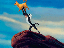 a monkey is holding a dog up in the air on top of a rock