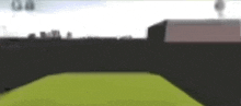 a blurred image of a person standing on a green field .