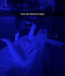 a person laying on a bed with their feet up and a snapchat caption that says fuck da discord opps