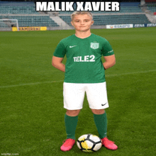 a soccer player named malik xavier stands on a field