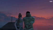 a man and a woman are looking at a sunset in a game