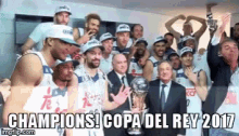 a group of basketball players are posing for a picture with a trophy and the caption champions copa del rey 2017