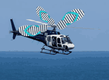 a blue and white helicopter with the number 283 on it