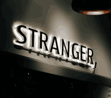 a black and white sign that says stranger