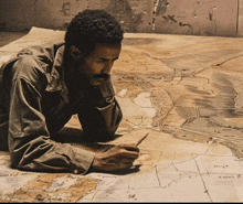 a man laying on the floor looking at a map with the letters sr on it