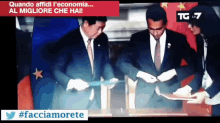 a tv screen shows a man in a suit and tie signing a document with the caption quando affidi l' economia