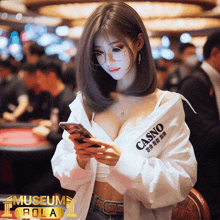 a woman wearing a shirt that says casino on it looks at her phone