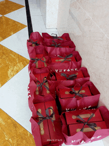 a row of red bags with the date of 2021.12.27 written on the bottom