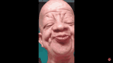 a close up of a bald man making a funny face with his mouth open