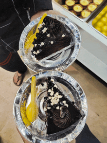 two plates of chocolate cake with a spoon on them