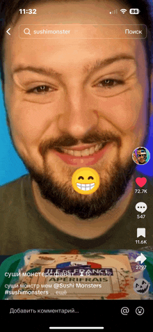 a man with a beard is smiling with a yellow smiley face on his face