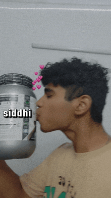 a young man kisses a container of siddhi protein