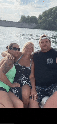 three people posing for a picture on a boat