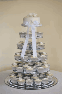 a cupcake tower with a wedding cake in the middle