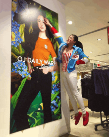 a woman is standing in front of a large oj daily ware poster