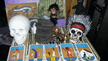 a table with tarot cards and a skull and a native american headdress