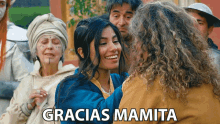 a group of people with the words gracias mamita on the top