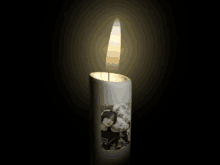 a white candle with a picture of a couple on it