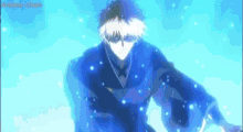 a man in a blue kimono is holding a sword in his hand in the snow .