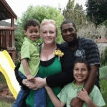 a family is posing for a picture together in front of a slide .