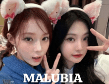 two girls wearing cat ears are posing for a picture with the name malubia