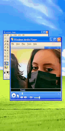 a windows media player window with a picture of a woman in a mask