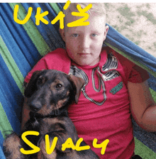 a boy laying in a hammock holding a dog with the name svacy written on the bottom