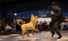 a man in a suit is dancing with a dog in front of an ice cream sign