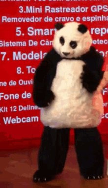 a panda bear mascot stands in front of a red sign that says mini rastreador gps removedor de cravo e espinha