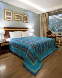 a bed with a blue and gold striped blanket on it