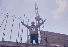 a man wearing a mask and a t-shirt that says ' mexico ' on it points to something