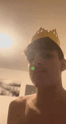 a man with a crown on his head has a green circle on his face