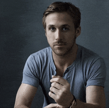 a man with a beard wearing a blue shirt and a watch